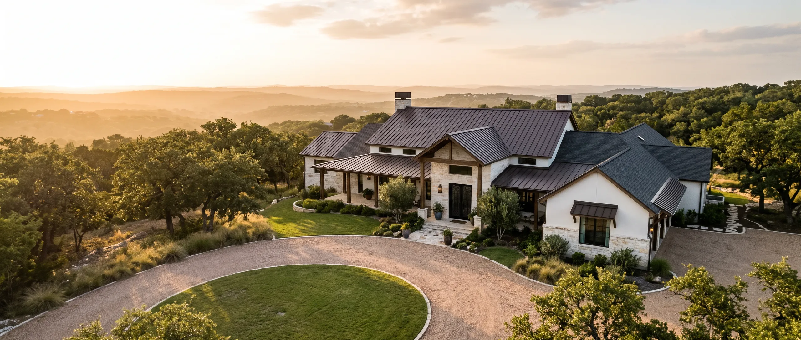 A Hill Country home with a new standing-seam metal roof at golden hour